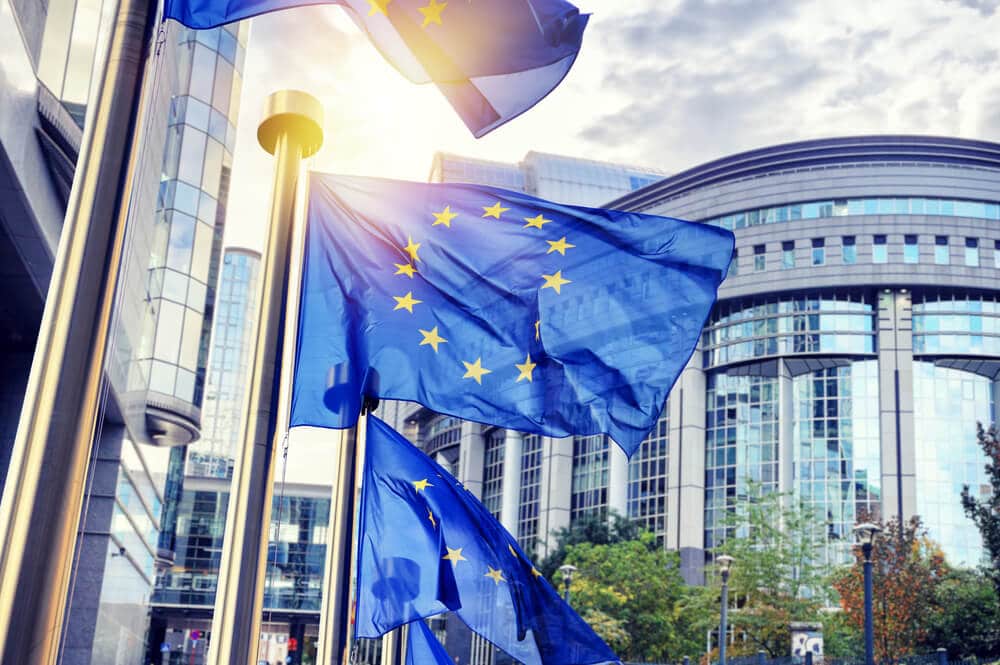 EU flags waving in front of European Parliament building. Brussels Belgium